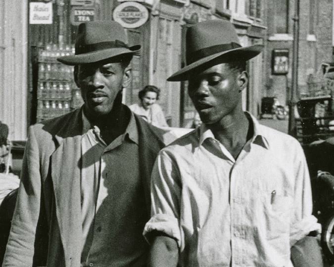 Two Caribbean men wearing Trilby hats walking in the Latimer Road area, North Kensington, Roger Mayne, 1957 ID no .IN16615. 