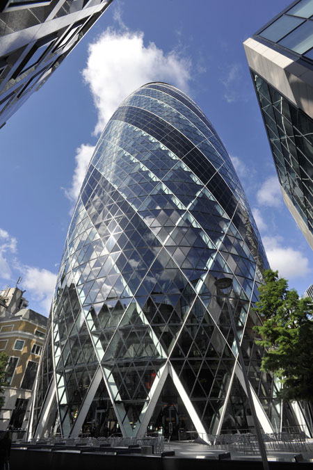 30 St Mary Axe, also known as the Gherkin and the Swiss Re Building. It is a skyscraper in London's main financial district, the City of London, completed in December 2003 and opened on 28 April 2004. It is 180 metres (591 ft) tall, with 40 floors. The building was designed by Lord Foster, his then business partner Ken Shuttleworth. Its construction symbolised the start of a new high-rise construction boom in London.
