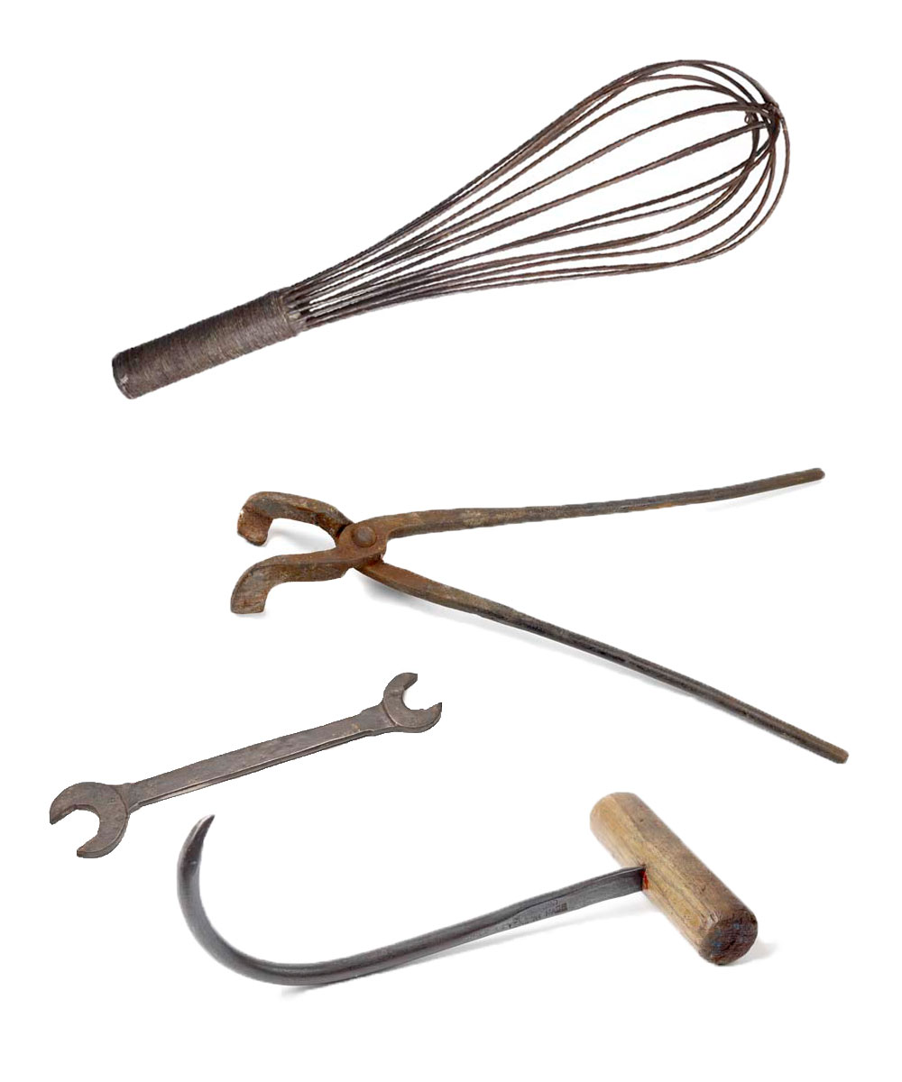 Photo of a whisk, spanner, glassmaker tongs and a docker's hook.