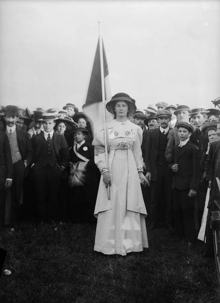 The Suffragette leader Charlotte Marsh poses for the photographer Christina Broom, before a male crowd assembled for a rally at Hyde Park in June 1910.