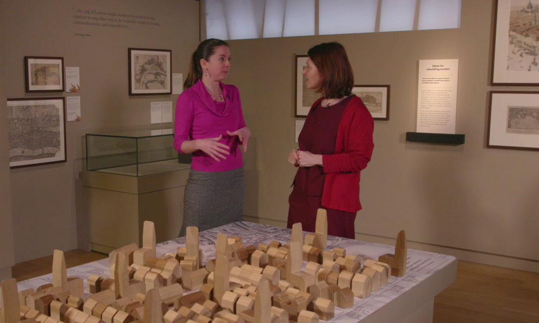 Meriel and Nina discuss the rebuilding of London above a large wooden diorama of the city.