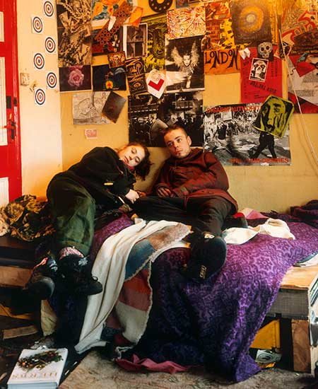 A couple lying on a bed at a house on Ellingfort Road, Hackney, from The Ghetto series, 1994 © Tom Hunter