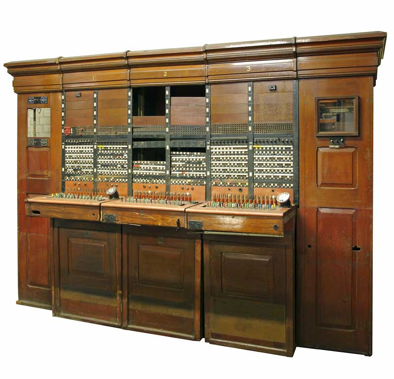 This Private Branch Exchange (PBX) switchboard was used in Buckingham Palace. It was originally installed in the inter-war years and used until the 1960s. Each of the three consoles has a rotary dial, twin headset jacks and a crank which operated a magneto for the back-up battery in the event of a power failure.