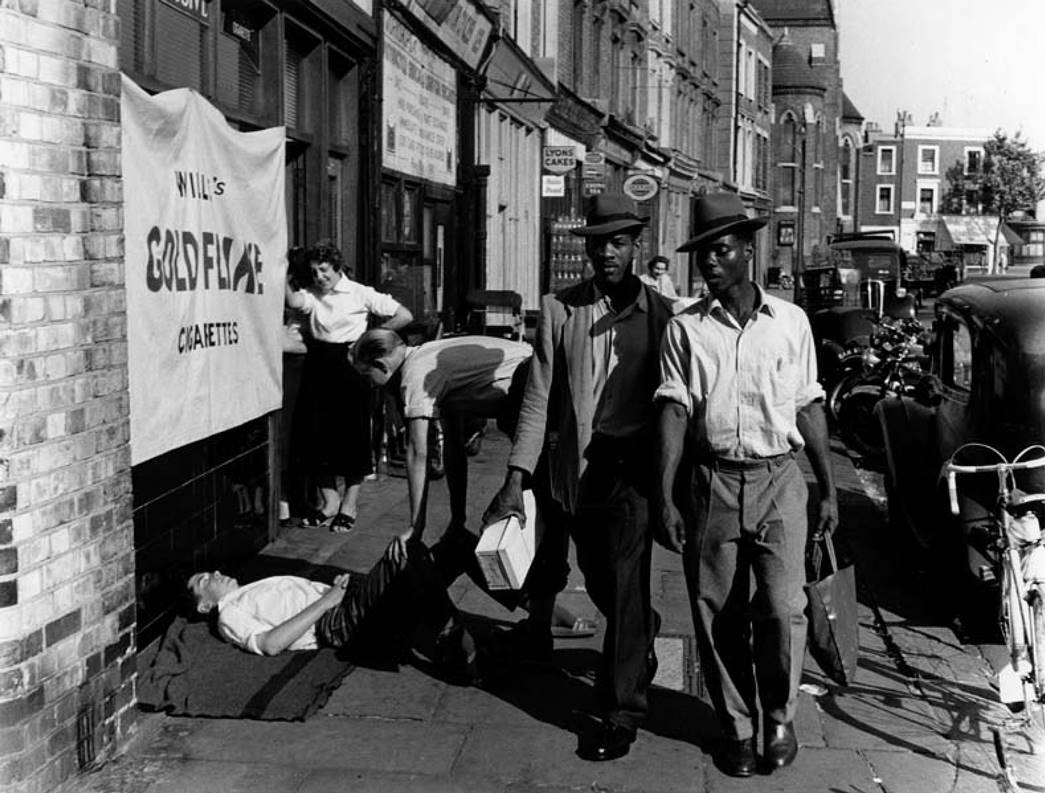 Two Caribbean men wearing Trilby hats walking in the Latimer Road area, North Kensington, Roger Mayne, 1957, ID no .IN16615. 
