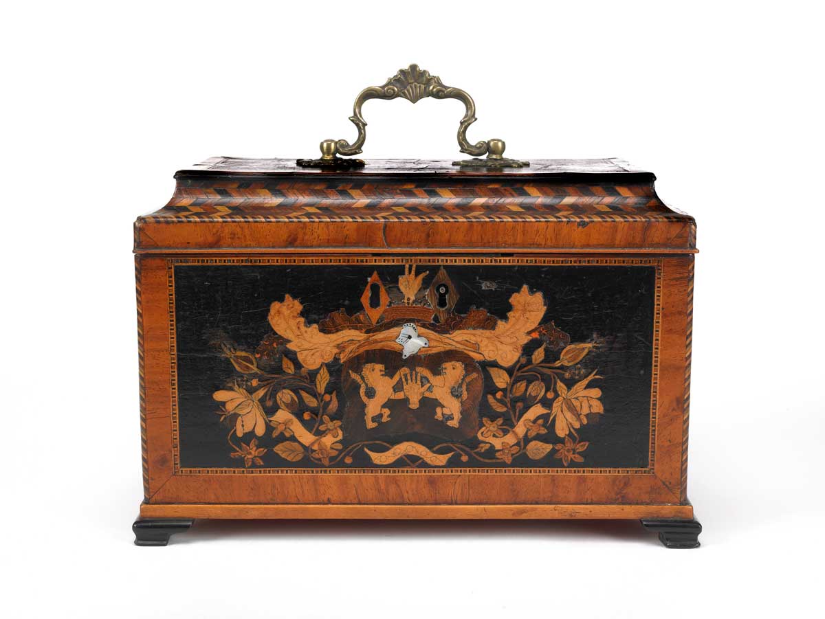 This inlaid wooden tea chest contains three canisters for storing different types of tea. 