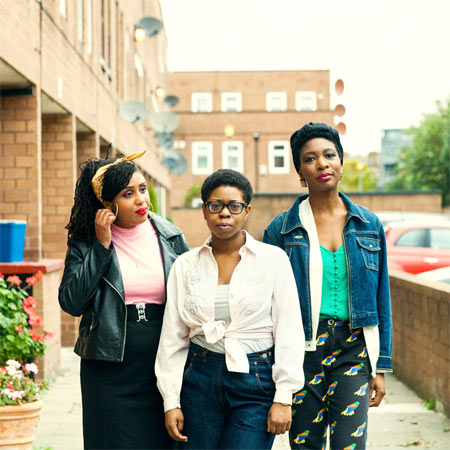 Lineup of three members of black female punk band Big Joanie.