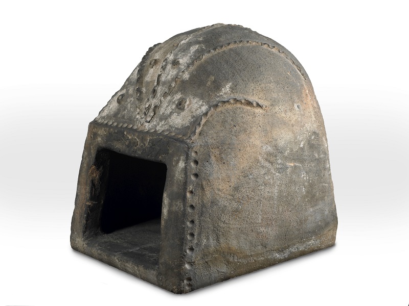 Portable 17th century ceramic oven which is missing its door. Heated by lighting a fire inside the oven and waiting for the oven to reach the right temperature. 
