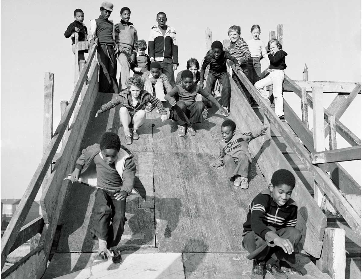 Children coming down a slide at the adventure playground in Hackney Marshes in 1978.