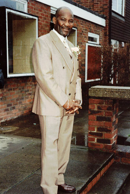 Lazare wearing the donated suit at a wedding