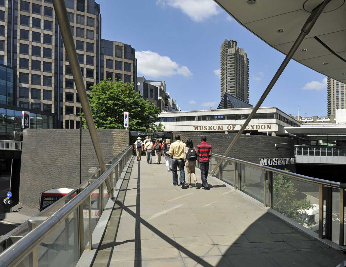 Photo of outside of Museum of London with the City in the background.