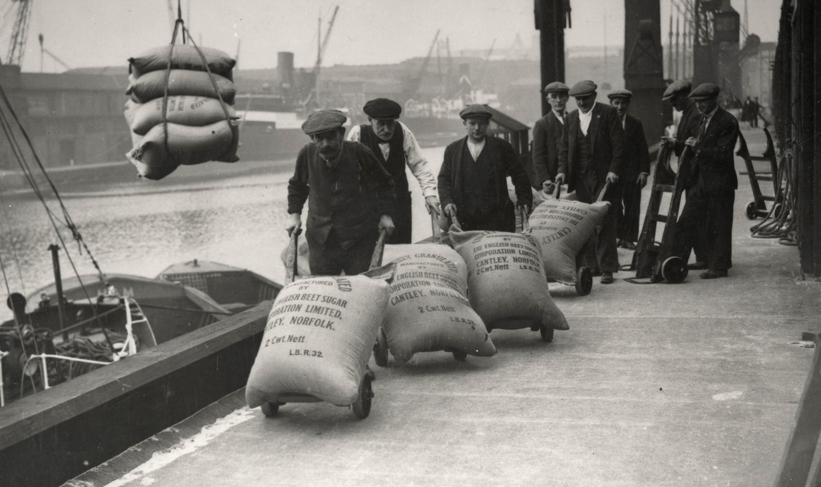Dockers at London Dock transporting sugar bags, 1920