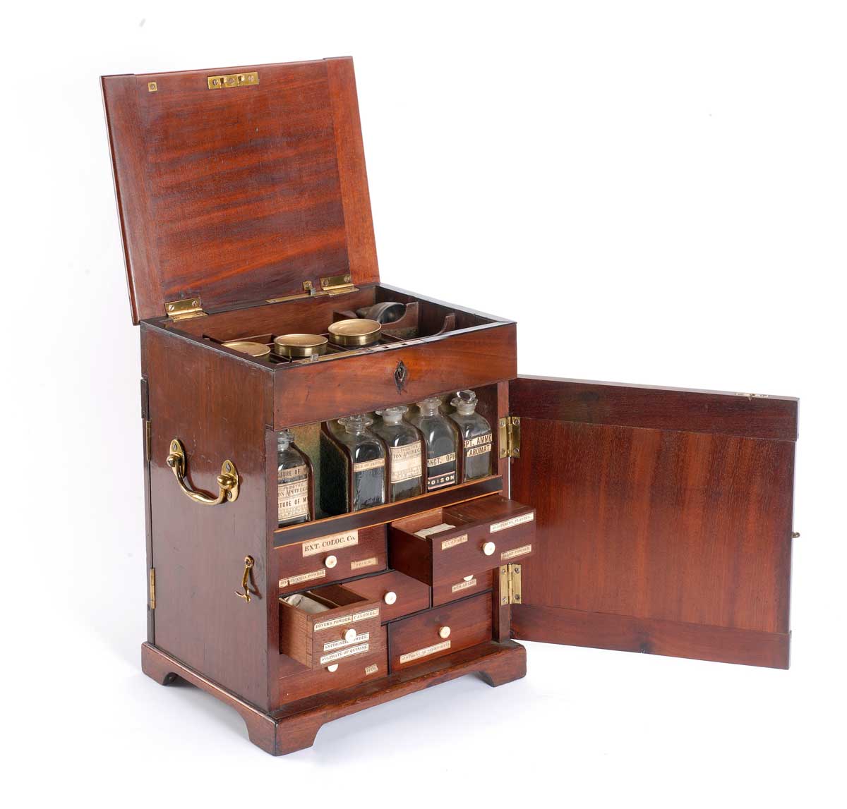 Medicine chest with eight drawers containing ointment jars, packets of medicine and bottles including essence of peppermint, opium, gum arabic and camphor. 