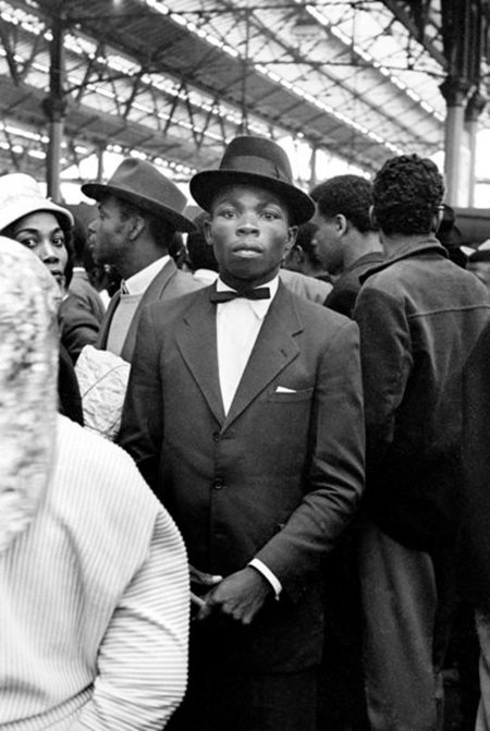 Smart dressed Caribbeans arriving and waiting at London’s Waterloo Station in 1962. Photograph by Howard Grey. (Courtesy: 
Studioplace/Howard Grey/ Wikimedia Commons)
