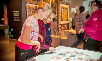 Children studying a case during a supplementary school visit to the Museum of London.