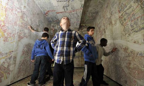 Children examine the Booth Poverty Map interactive display.