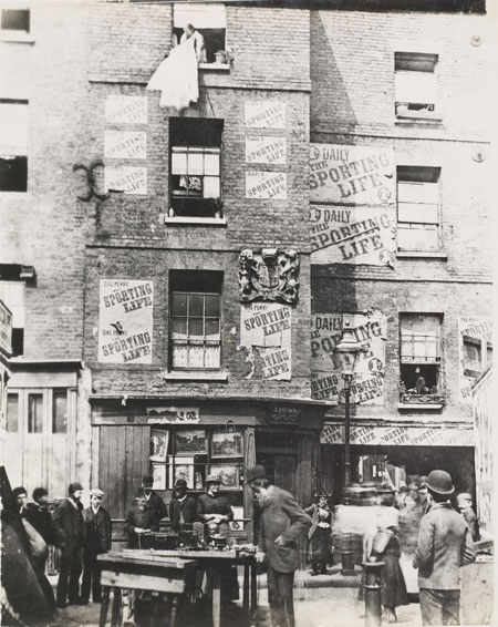 In the early nineteenth century, this market situated at the south-west corner of Lincoln’s Inn Fields, sold meat, fish and fresh vegetables. There were many taverns in the vicinity. Joe Grimaldi, the famous clown, was born in Stanhope Street adjoining the market. Dickens alluded to the area as a place that had ‘houses of a poor description, swarming with inhabitants’. This ‘rookery’ or slum quarter was swept away at the start of the twentieth century forming part of the Aldwych and Kingsway improvement scheme.
