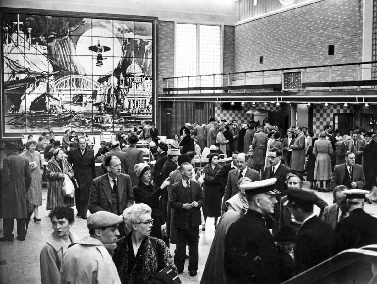 Crowds of people walk through the Tilbury Passenger Terminal after it was first built.  