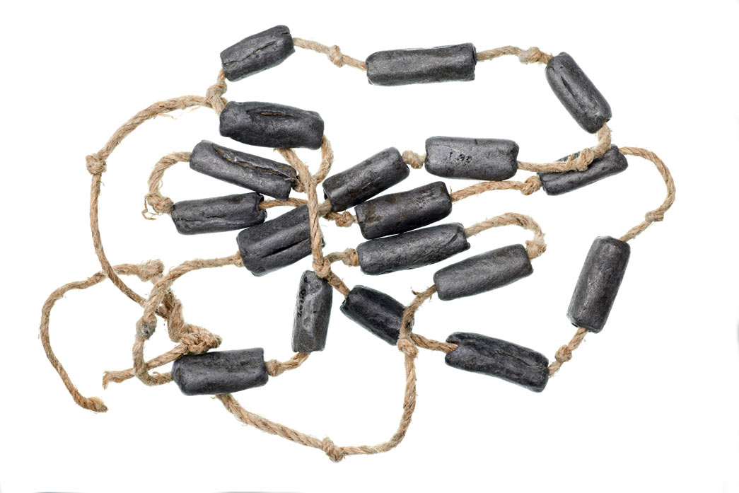 Eighteen lead weights from a fishing net found at the bottom of the wreck of a 15th-century ship in the Thames at Blackfriars