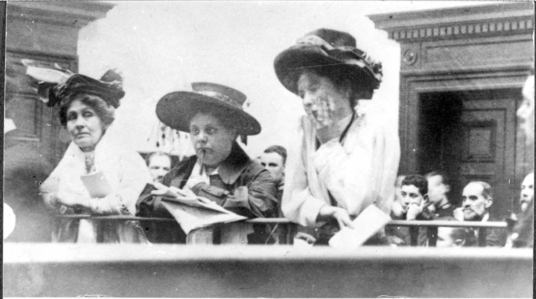 Christabel Pankhurst, Flora Drummond and Emmeline Pankhurst in Court, October 1908. This court appearance refers to the arrest of the suffragette leaders for inciting a riot and urging supporters to 'rush' the House of Commons. 
