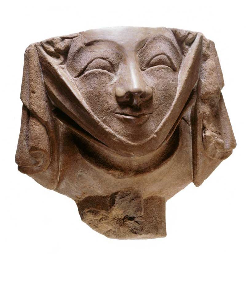 Carved head representing a fashionably dressed young woman with a wimple or neck cloth under her chin. This would have decorated a building in medieval London.
