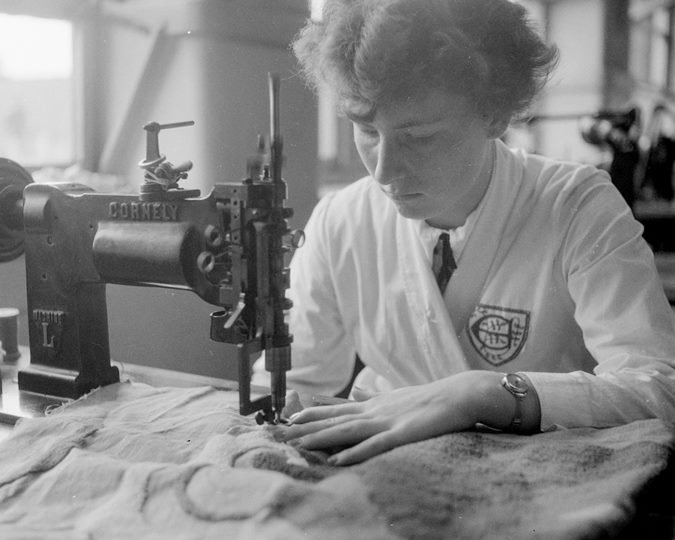 From a group of images relating to Shoreditch College for the Garment Trades, June 1955. The image shows a student doing machine embroidery on a Cornely machine.